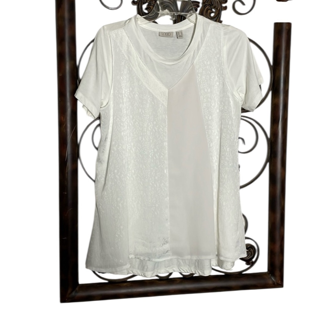 Women’s size small white logo by Laurie Goldstein blouse